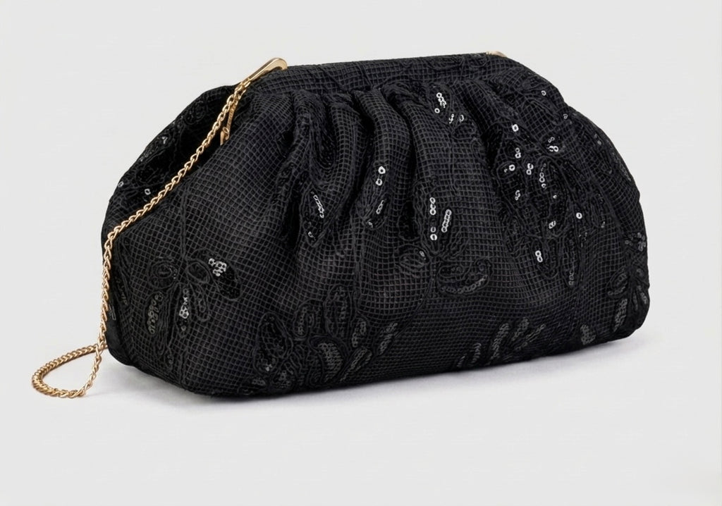 Hand-carried clutch bag in fabric adorned with floral patterns and sequins