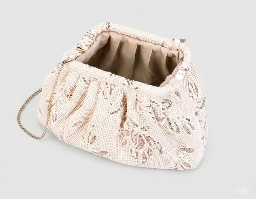 Hand-carried clutch bag in fabric adorned with floral patterns and sequins